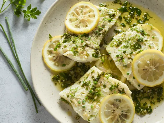 Fresh healthy wild fish with herbs and lemon